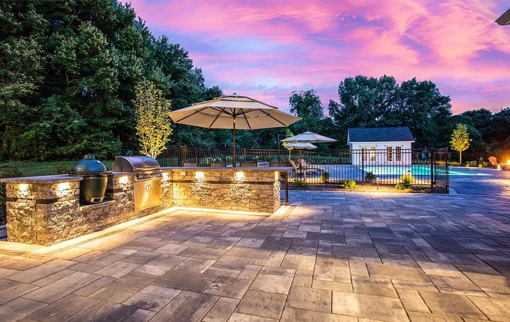 Custom stone work, outdoor kitchen, and pool deck of patio pavers