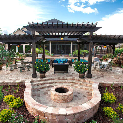 Hardscape Design, brick patio with firepit and retaining wall for seating and a pergola