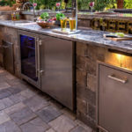 Outdoor kitchen with stainless steel appliances and built in grill