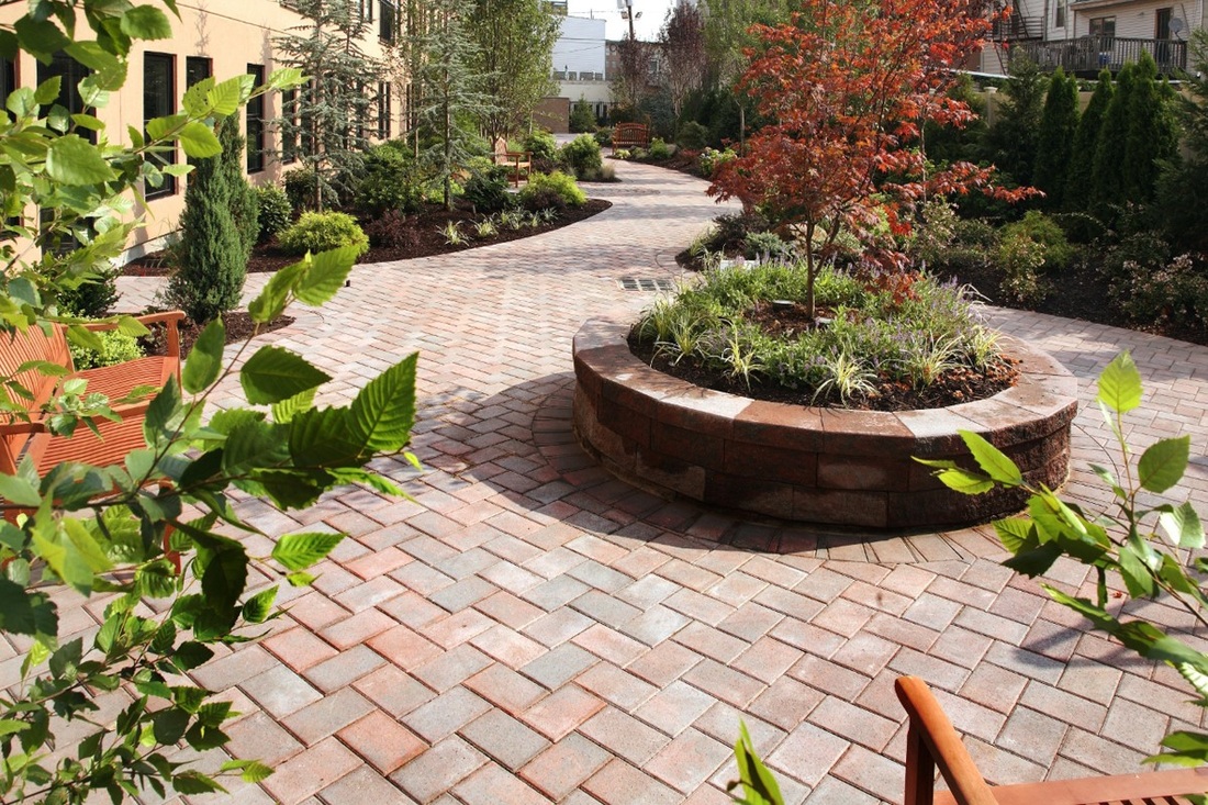 Brick walkway with circle retaining wall garden
