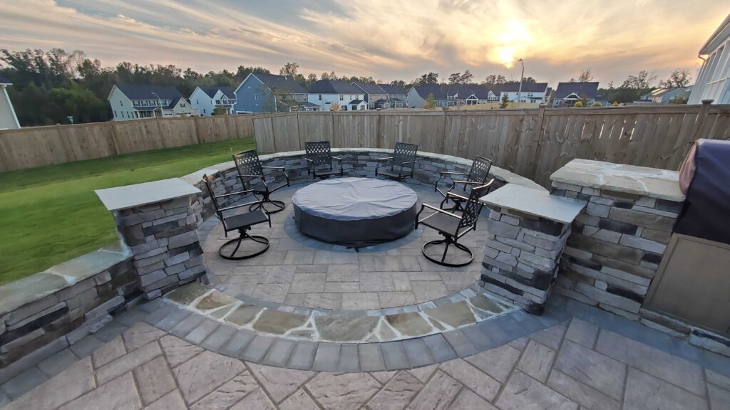 Outdoor living space with grill/ island, retaining wall and custom patio paver