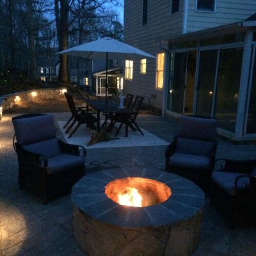Custom lit fire pit with retain wall and custom lighting