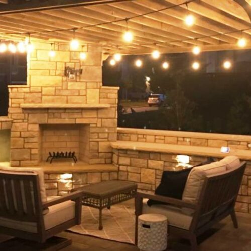 Outdoor Living, pergola covering a fireplace that has a high top on one side and storage for wood on the other
