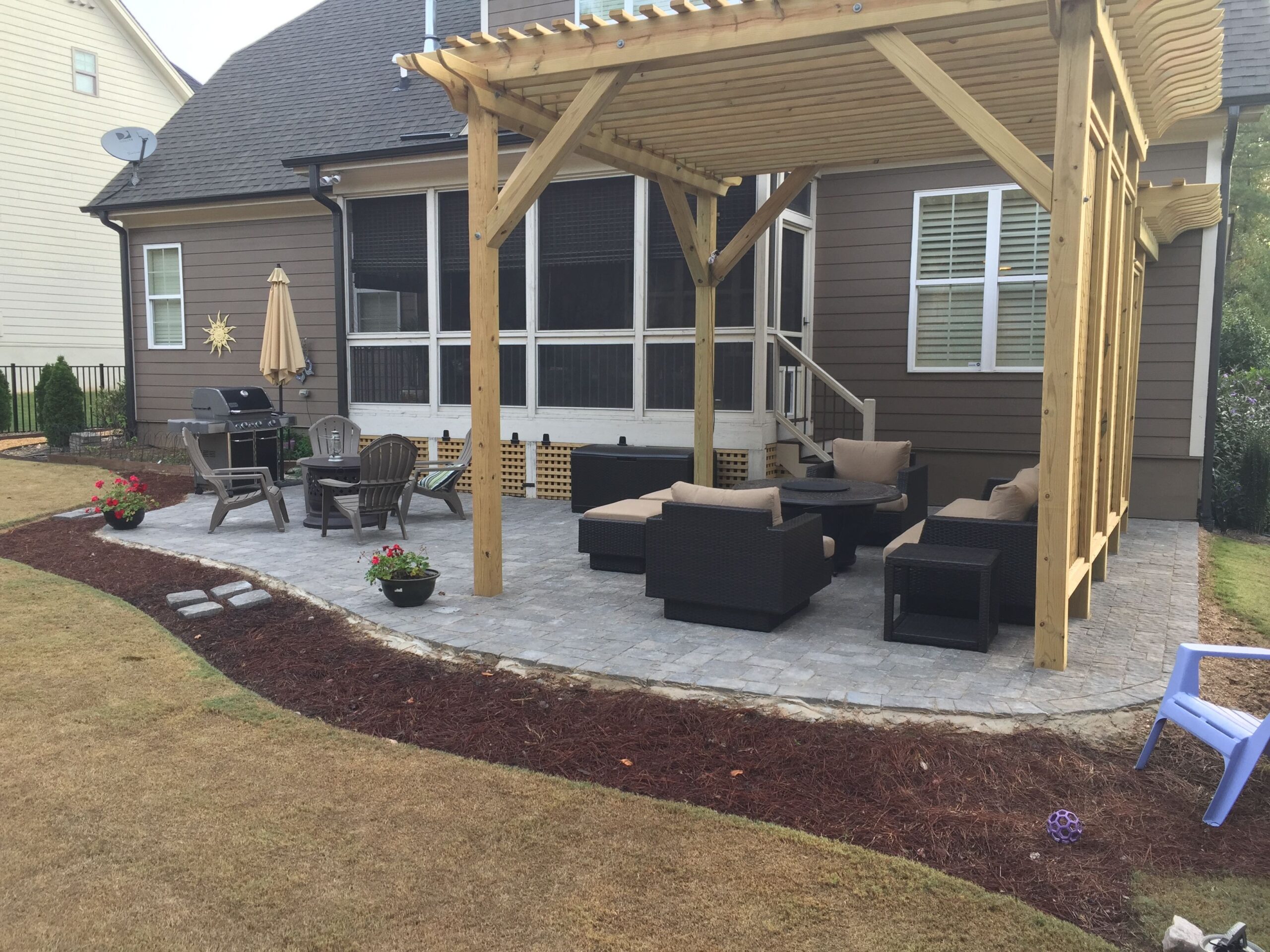 Outdoor living space with custom stone paver patio and gazebo over the patio